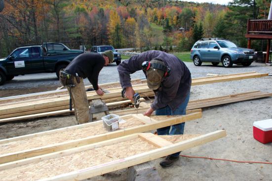 Where the lower rafter would sit atop the upper rafter at the joint, 1x6 web stiffeners were applied to the I-joists, locateded so they'd line up vertically above the web stiffeners in the lower roof and above the bearing wall.