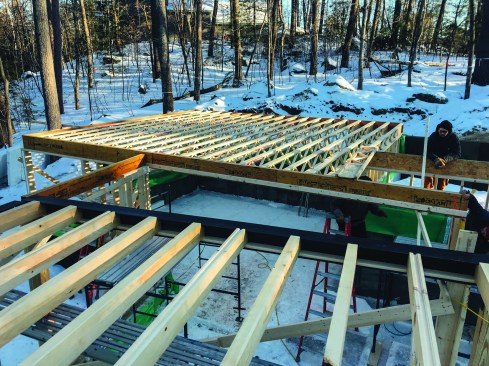 A stiff mid-span steel beam was integral.