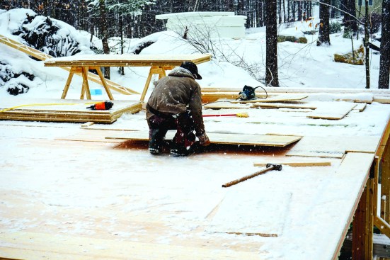 Then the crew covered the whole layer of boards with a top course of AdvanTech subflooring.