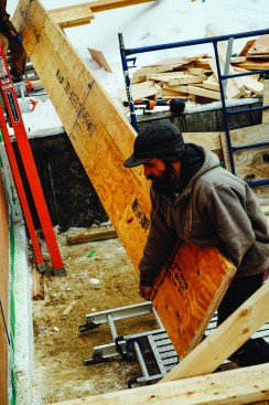 Engineered LVL material lets carpenters assemble high-capacity beams on site, using manageable pieces with uniform strength characteristics. Carpenter Matt Friel helped carry 28-foot pieces onto the homeâs floor deck.