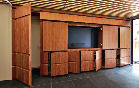 KUBE Architecture built abundant yet concealed shelving and storage into the walls of this D.C.-area home.