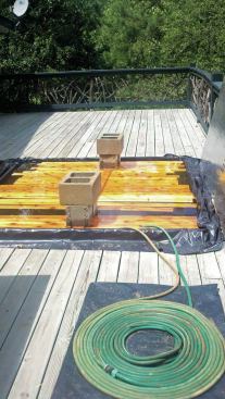 When building curved railings, the author soaks 1x4 cedar rail stock in a temporary pool made with 2x4s and a sheet of black plastic.