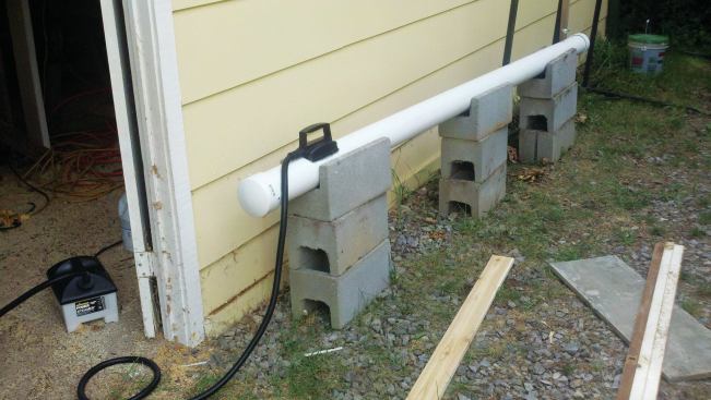 After soaking, the 1x4s are steamed in a PVC pipe, with a wallpaper steamer providing the steam. It takes one steamer tank of water for gentle curves, and about two tanks to steam the lumber long enough to bend it to a tighter curve.