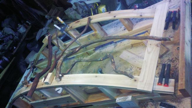 Assembly typically begins with longer branches left over from a previous section. Coped cuts are sometimes required where large branches intersect. To avoid splitting the branches, the author fastens them to the rails and to each other using galvanized 16-gauge finish nails.