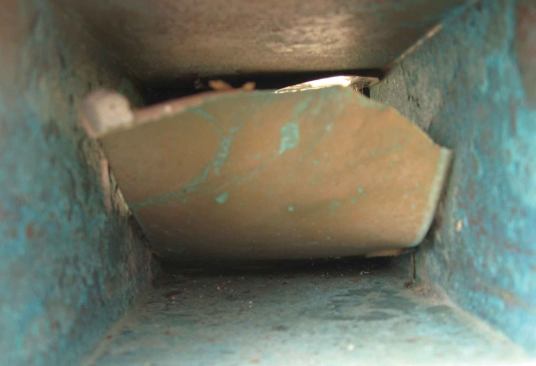 Prior to applying our primer and waterproof top coating, we sand the interior of the scupper to promote adhesion of the coatings to the metal. This prevents the coating from debonding as the copper oxidizes, as it has on this scupper in photo.