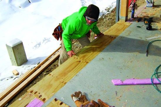 A strip of treated plywood was fit over the mudsill and the rigid foam.