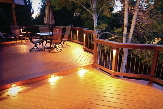 In a successful deck lighting design, there is a balance between areas of light and areas of shadow. Note how these post-mounted fixtures cast their light down and away from the eye.