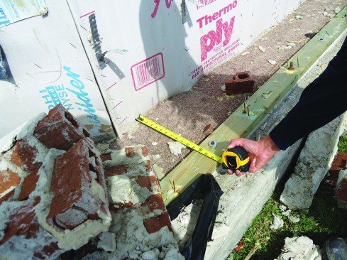 A wall has slid off where non-structural sheathing pulled away from the sill.
