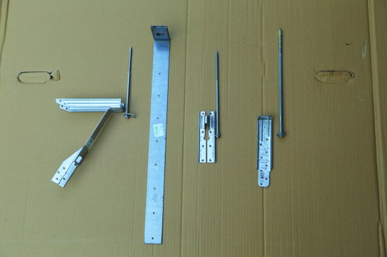 Examples of hardware that meets the 750-lb. requirement include (above right, from left to right in photo) MiTek/USP ADTT, MiTek/LTS19, Simpson Strong-Tie DTT1, and FastenMaster LTS.