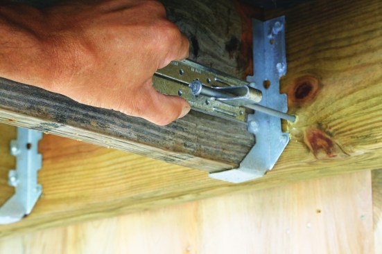Next, slide the tie over the screw.