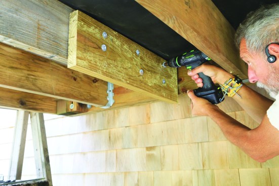 Blocking can be installed to help align the hardware with the deck and house framing. Here, the author fastened the block to the joist with SST TimberHex HDG screws.