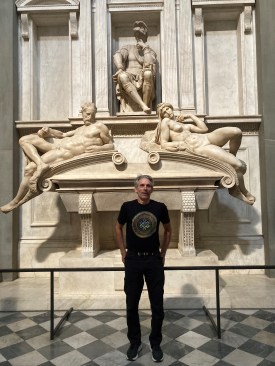 The author stands in front of the sculptures, Dusk (figure on left) and Dawn (figure on right), and the seated figure of Lorenzo II de Medici, Duke of Urbino, for whose tomb these sculptures were created. 