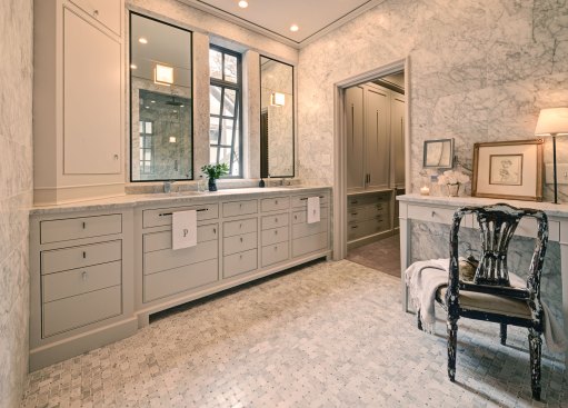 For this "marble box" bathroom design, DeRhodes Construction used honed Carrera marble throughout to lovely effect. Overhead recessed lighting by Lightolier (lightolier.com) illumates the space. See the full article about this award-winning project.