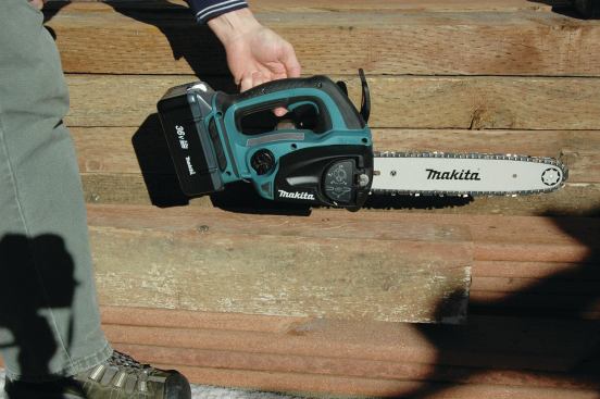 The flap covering the bar adjustment knob can be flipped out and rotated to adjust chain tension.