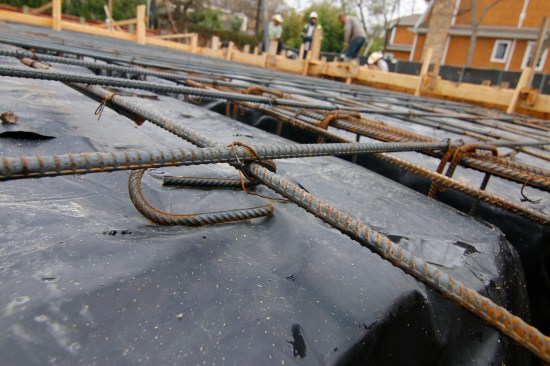 The carton forms were covered with a durable, 15-mil poly, and the rebar was wired tightly, with plenty of stand-offs to keep the reinforcing in the midsection of slab.