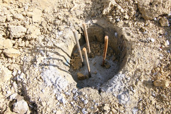 The holes provided the form for the concrete, and we didn’t want them filling up with dirt, so the foundation crew installed the cages and poured all the holes they could drill in a day.
