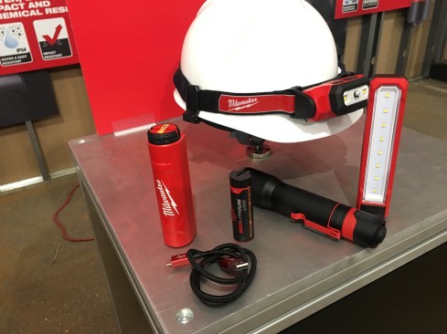 Here's a look at the rechargeable headlamp and task light from the previous slides, as well as a couple of new items. A rechargeable flashlight (the black item with the red clip in the middle; model number 2110-21) gives off 700 lumens, has flood and spot features, and up to 16 hours of runtime. On the left is a Redlithium single-cell battery and charger, along with the USB charge cord. Available September 2017. Cost TBD.