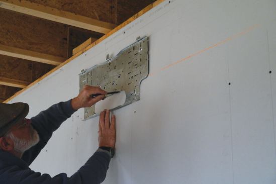 The author traces around the knock-out for the unit’s through-wall penentrations ...

