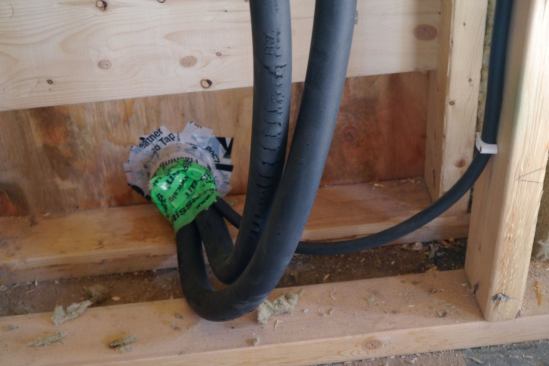 To curb air leaks where the line set passes through sheathing, it’s wrapped with Siga Rissan tape. Scuff marks and tears on the foam insulation will be repaired with duct tape.