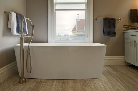 The master bathroom of this remodeled Painted Lady includes a freestanding tub, the perfect melding of Victorian and modern design.