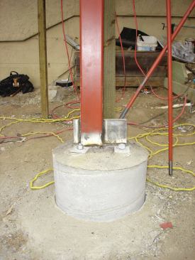 The multistory deck is anchored to the hillside by five 20-foot-deep reinforced concrete footings. Two of the footings support a steel moment frame, which is welded to 1-inch-thick steel plates fitted with 24-inch-long anchor bolts embedded in the concrete. 