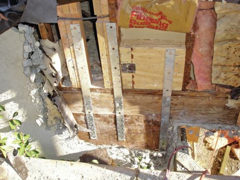 Vertical metal straps were fastened to the foundation and directly to the studs in several locations to reinforce the connection between the wall framing and the foundation.