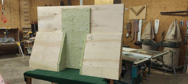 Sometimes an insulated flue runs behind the TV, so when building a recessed TV cabinet, the author will jog around the flue pipe and add fireproof rigid insulation about 2 inches thick for extra insurance.