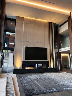 Concealed LED strip lighting was used to accentuate the high, vaulted ceiling planes in the main living room.
