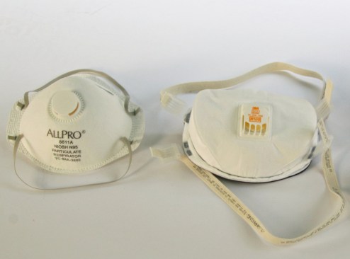 A NIOSH-approved disposable filtering facepiece respirator (FFR), such as an N95 (above left) or N100 (above right)  can be used for protecting workers from particulates, but not vapors and gases. These models have adjustable double head straps, which provide a better seal than the ear loops found on KN95s.