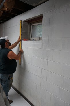 Toby draws layout lines for placing the straps every 4 feet on-center. 