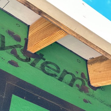 Roof-to-wall seal. For an effective air seal around rafters, the crew cuts the sheathing to fit over the bird blocks between rafters, and the joint between the sheathing and the rafter tails is carefully filled with fluid-applied. 