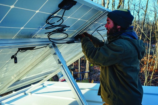 David Kelly encourages custom homebuilders to learn enough to install solar panels themselves as a way to gain a cost advantage. Here, Kelly makes basic modular wiring connections using snap connectors.