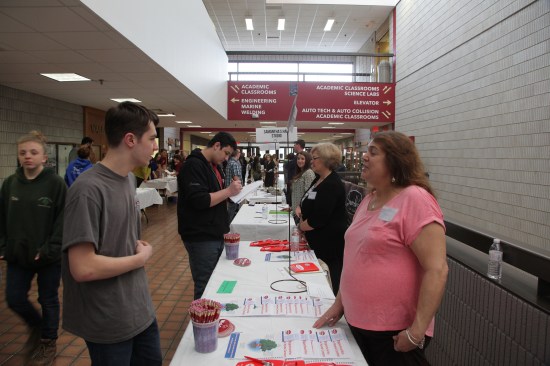 Barbara Lennon, an HR representative for MidCape Home Centers talks to a tech student about how his skills could be put to good use at the building supply center.