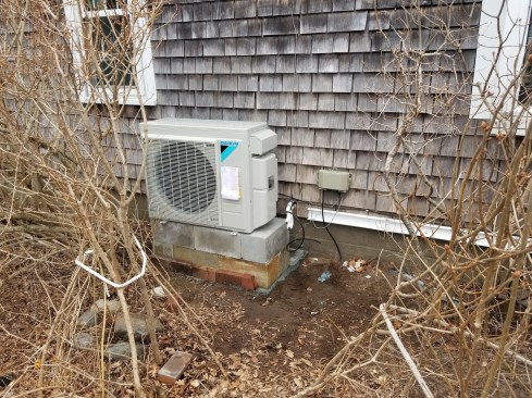Two mini-splits that run off of this single outdoor compressor will be the new source of heat for the cottage. The fireplace insert will remain for ambiance and as a back up heat source. The minis will also provide AC for the cottage when needed.