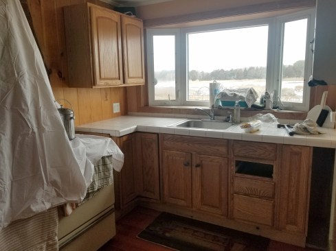With a coating of snow on the marsh outside, the old kitchen awaits demolition inside.