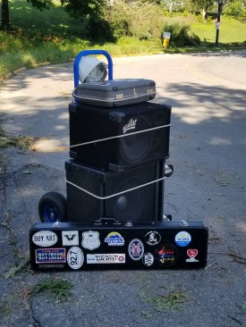With the road closed to all access except foot traffic, the author was forced to lash his musical equipment to a hand truck in order to make a gig on the day after the storm. He wore the hard hat seen on top to get through the safety zone.