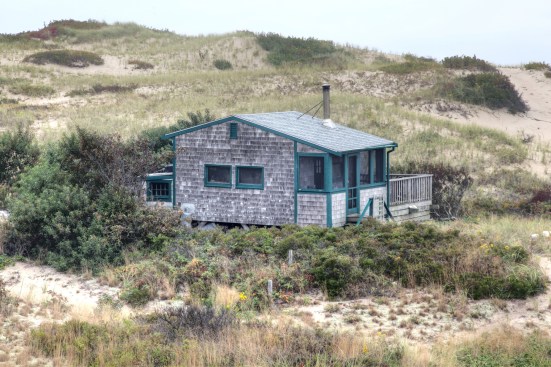 View showing the main volume of the house with the screen porch on one side and the "garage" on the other.