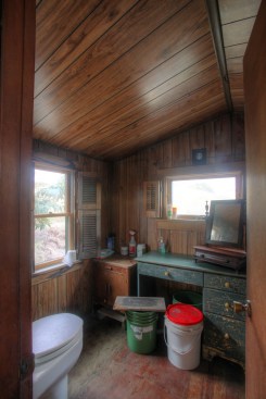 The toilet room off of the bedroom is home to the composting toilet. The bucket on the left holds peat moss that is added to the toilet after each use, and the other bucket is for soiled paperthat is not to be put in the toilet.
