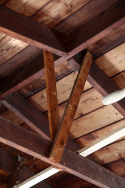 Odd pieces of 1x3 run from the rafters down to the rafter ties, the function of which are a mystery.