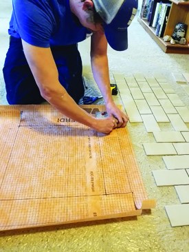 Cut out. While Schluter doesn’t prescribe a specific way seams should lap, the author adheres to a shingling method to prevent potential water leaks. To achieve this, the top, or “ceiling,” of the inset is cut from the interior box outward, leaving flaps that will fold over the sides.