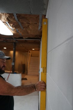 Structural strapping, which is very strong in tension, is typically specified to reinforce foundation walls that bow inward, as is the case on this project.  (Strapping can also be used for walls that tip in ward or that have sheared, with part of the wall pushed inward by hydrostatic pressure. The engineering and product requirements will vary for each case.)