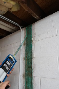 The goal is to have the strapping fully saturated and encased within the epoxy. To accomplish this, Toby adds more epoxy.