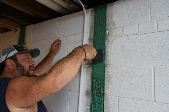 Toby smooths out the new epoxy to create an even epoxy surface