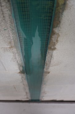 With this particular reinforcing strap, a thin sheet of plastic is applied on top of  the epoxy.