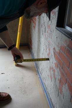 The author checks against the laser to see how they are progressing as they lift the ridge and pull in the walls.