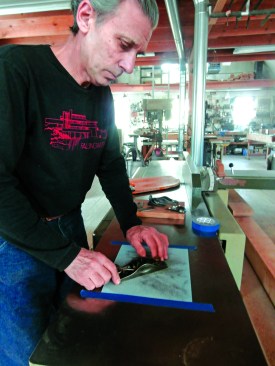 To tune a plane, the author starts by flattening and polishing the sole on a sheet of sandpaper taped to the bed of his jointer. Roll or break all the edges of the plane body.