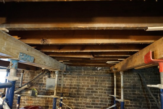 To begin repairs, the crew erected emergency shoring on each side of where a steel beam will be placed to support the load-bearing wall.