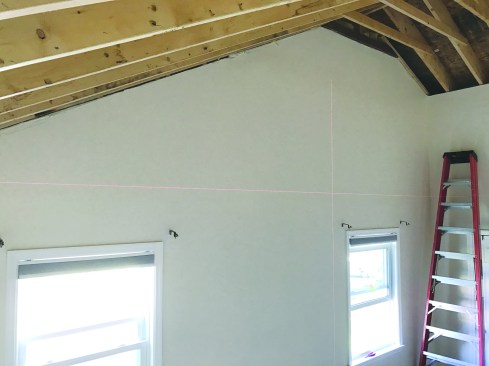 The owner wanted to replace the high cathedral ceiling with a conventional flat ceiling.