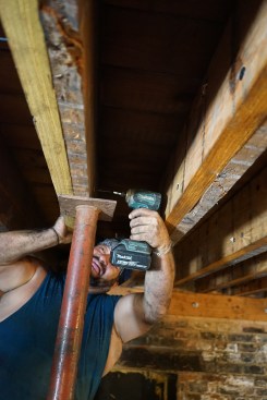 Toby fastens the new LVL with structural screws, Working from both sides of the assembly.