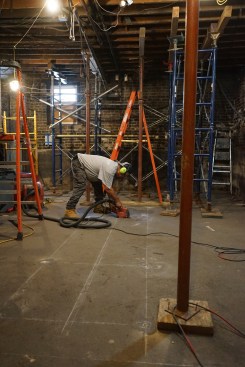 With the shoring in place, the crew cuts open the basement slab to dig 36-by-36-by-18-inch footings for columns to support the new steel I-beam.
